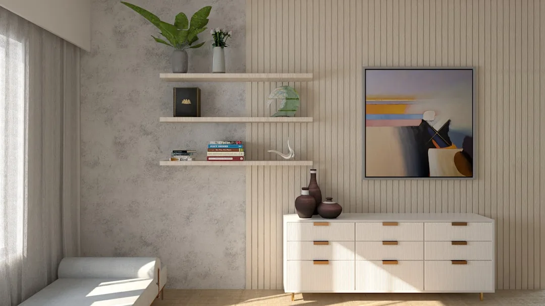 Floating wall shelves with books and decor beside a white ribbed dresser in a modern minimalist living room