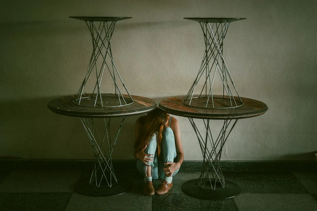 Two round pedestal bar tables with geometric wire bases against a wall, illustrating pedestal base table structure