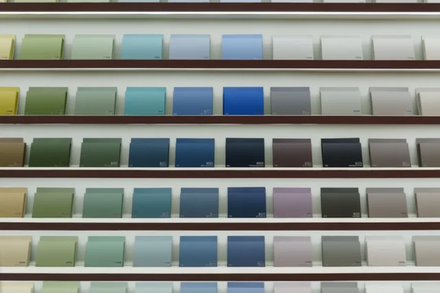Paint color swatches on display shelves showing fu
