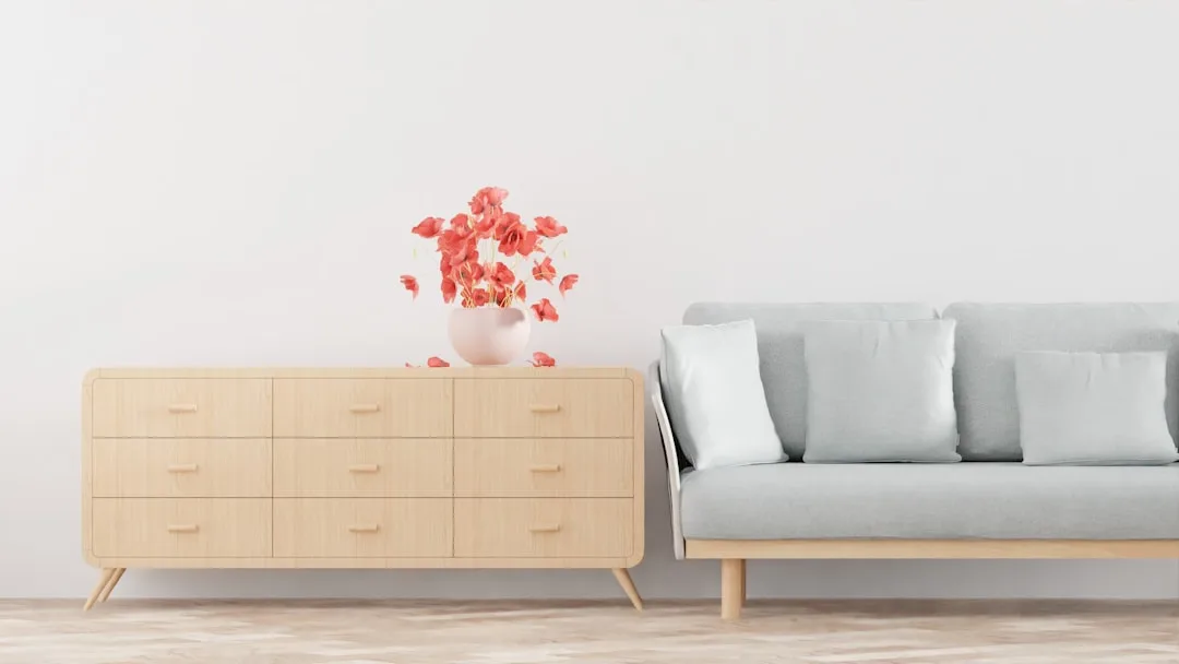 Minimalist living room with light wood dresser and gray sofa showing scale and proportion in furniture arrangement