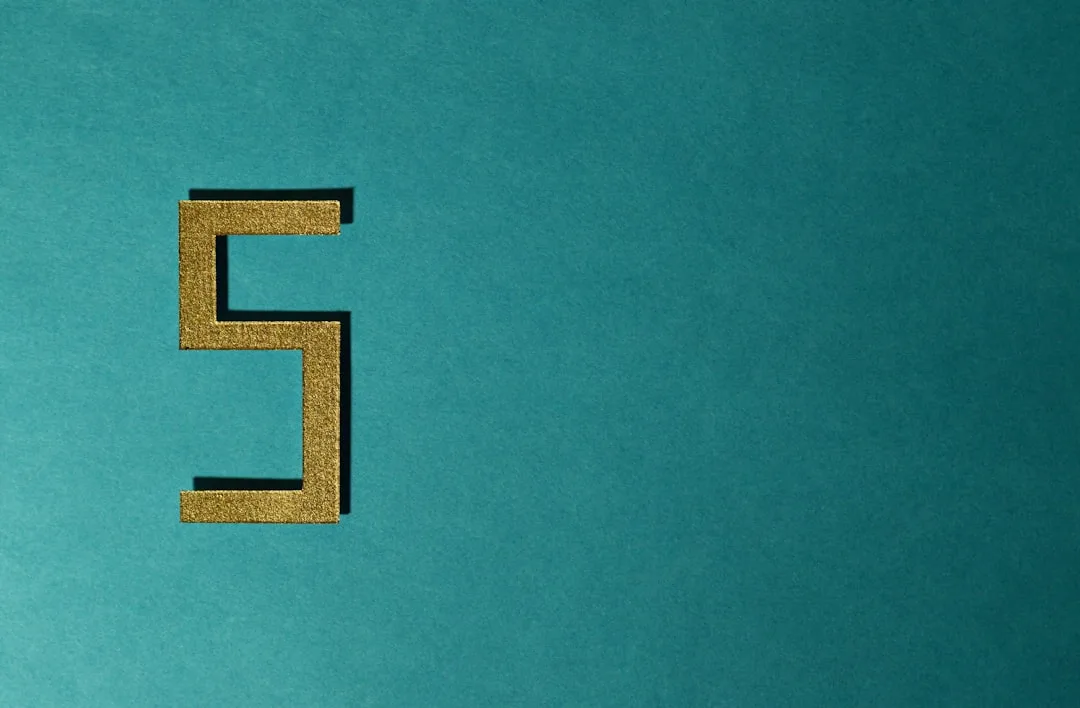 Gold glitter number 5 on teal background representing five split techniques in gymnastics and flexibility training