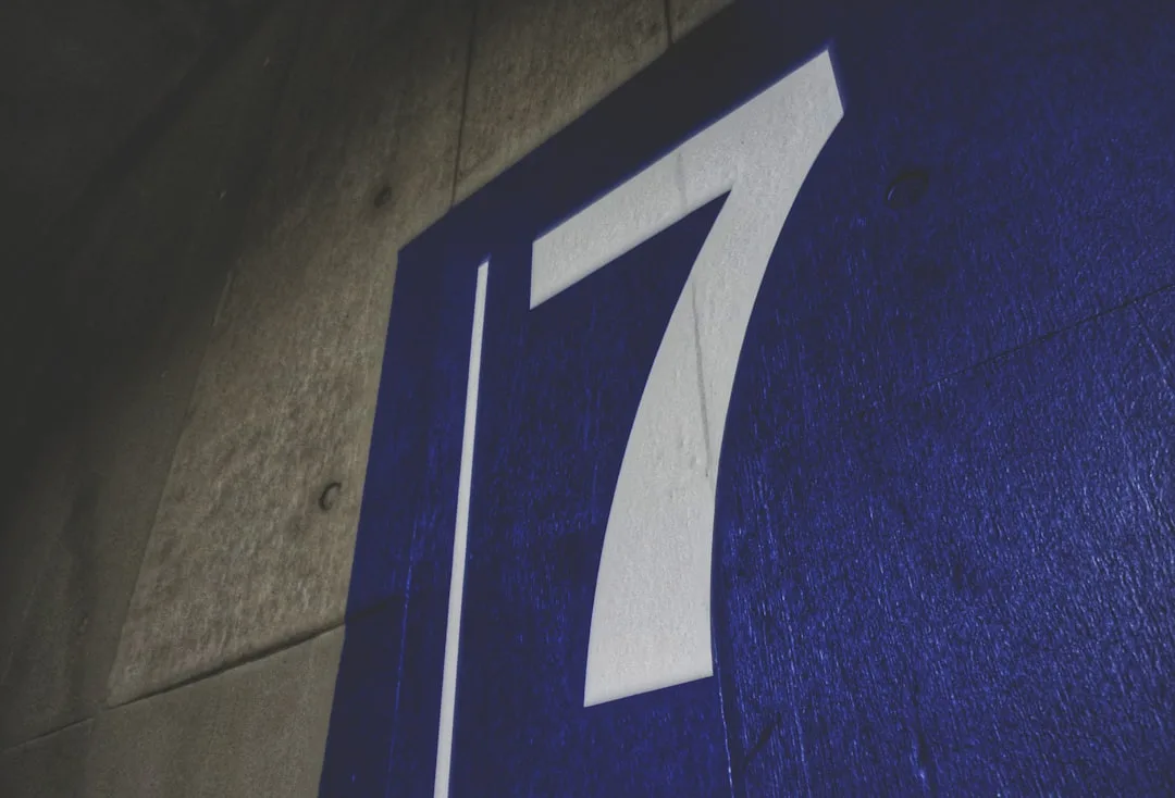 Bold white number 17 on a blue surface illustrating the 7-and-7 rule concept for ceiling height and floor width