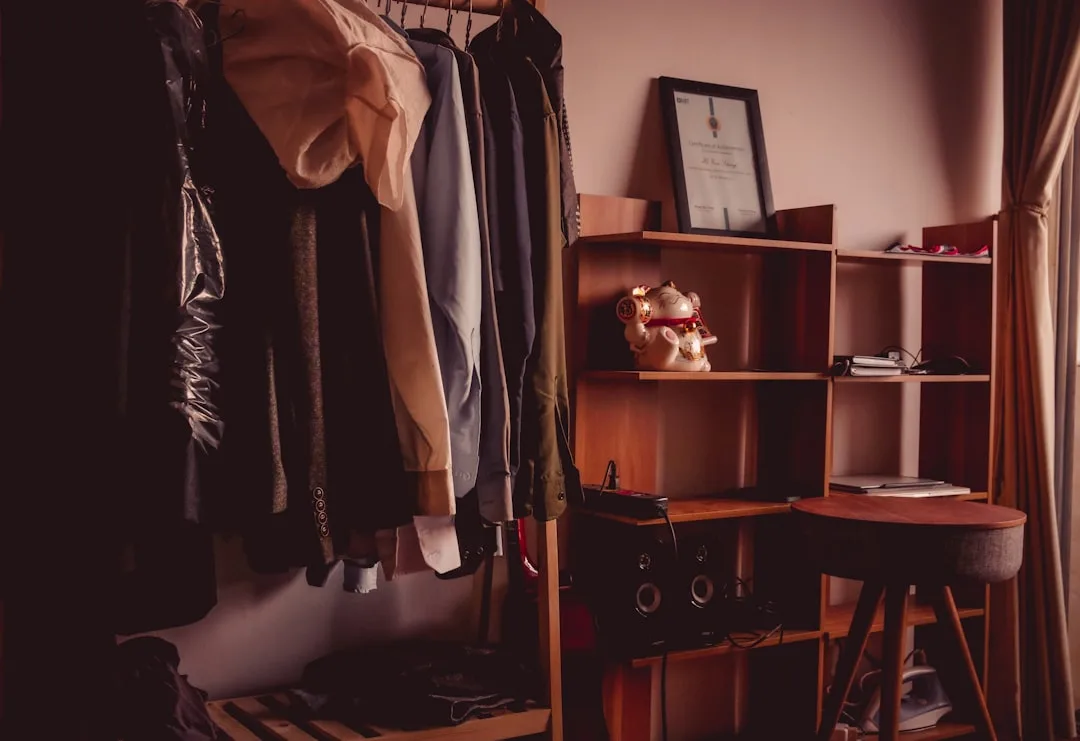 Small bedroom closet organization without dresser using open clothing rack and wooden shelving unit