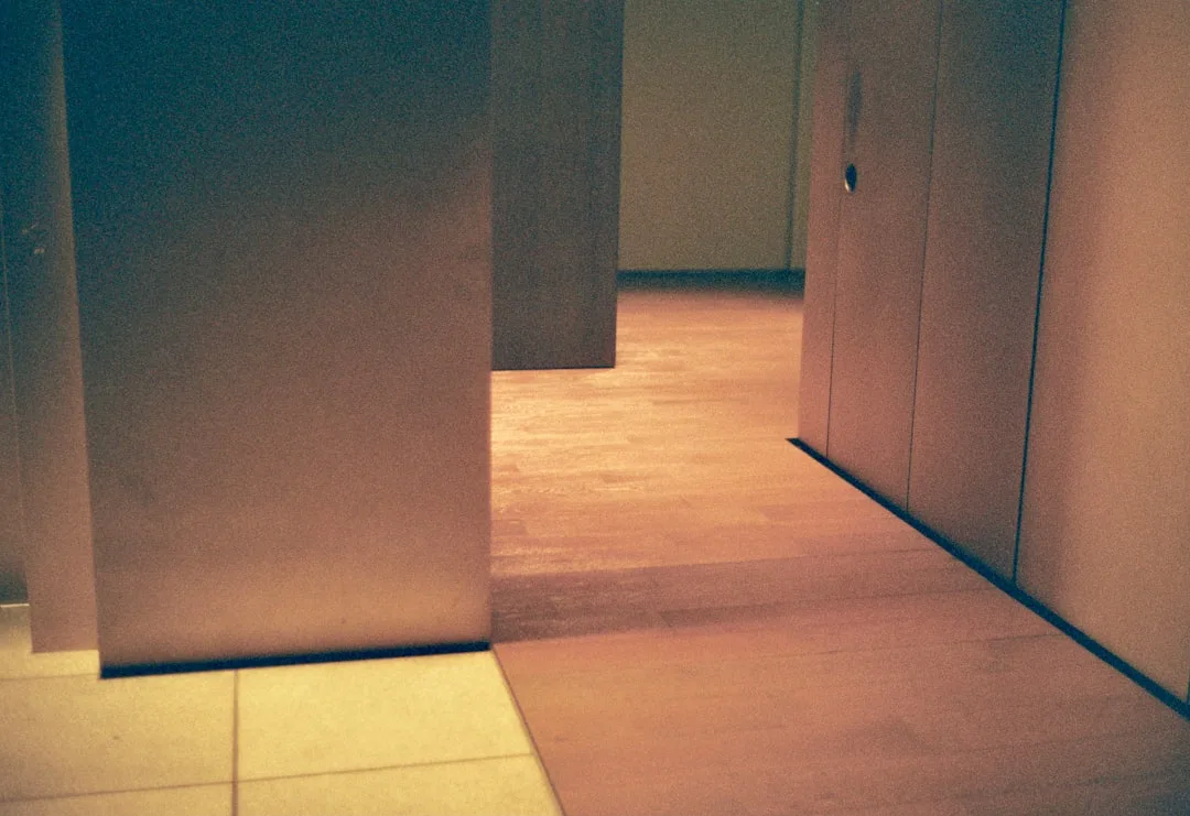 Narrow hallway with multiple doors illustrating door swing conflicts in combined bath-closet layout planning