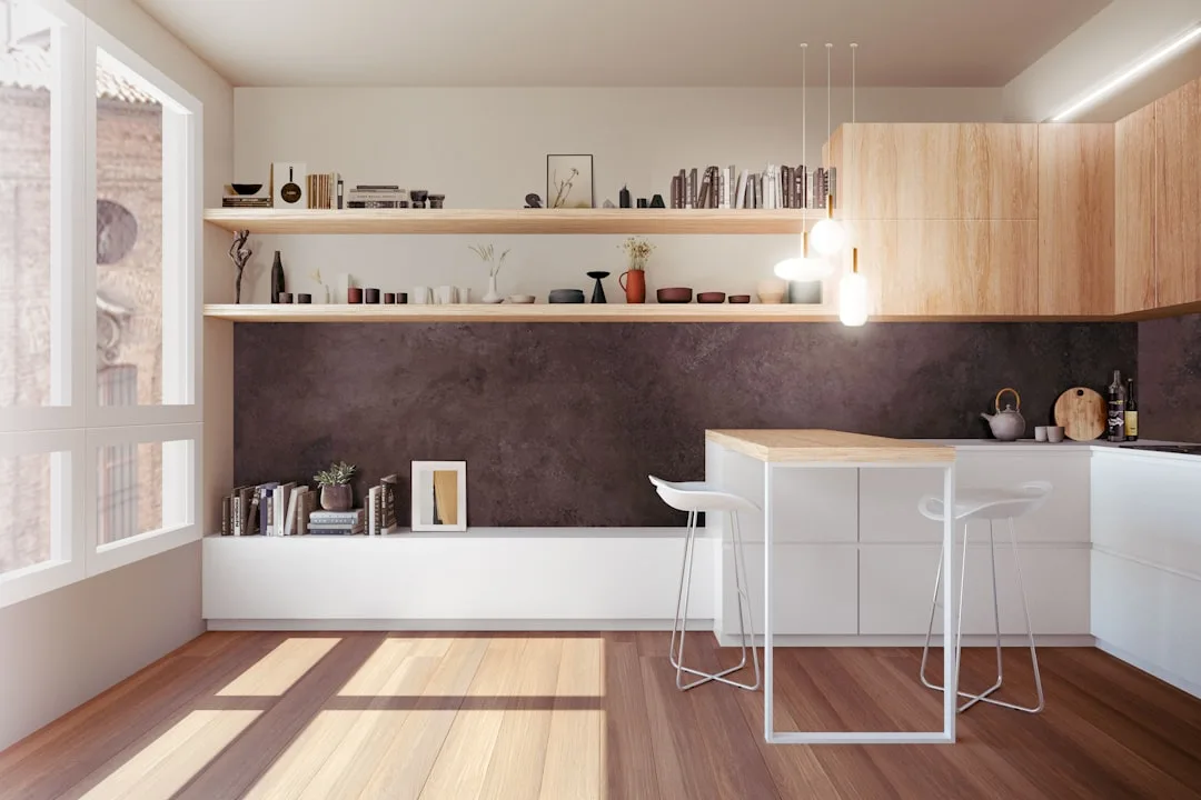 Modern kitchen with open wood shelves displaying curated ceramics, vases, and books above a dark stone backsplash