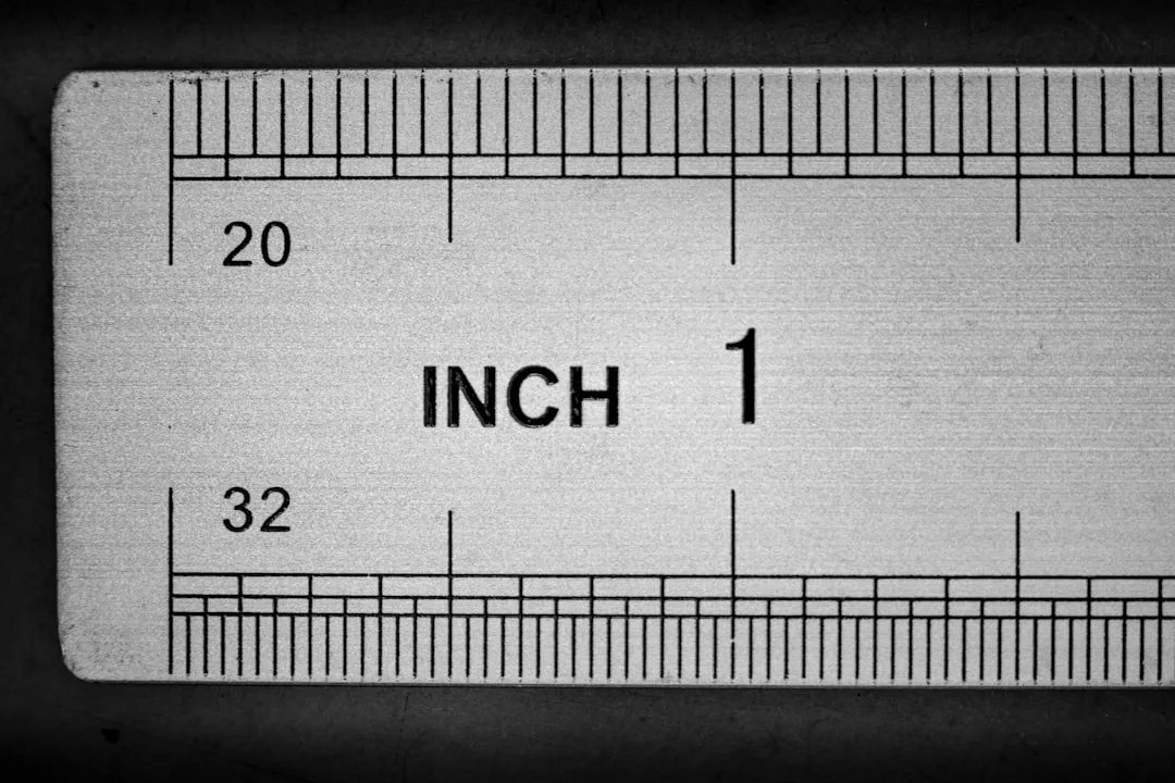 Close-up of a metal ruler showing inch measurements in 20ths and 32nds for precise kitchen dining layout planning
