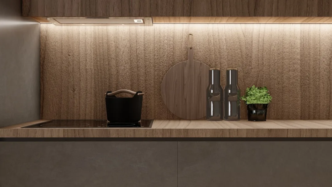 Modern kitchen with warm LED strip under-cabinet lighting illuminating wood backsplash and countertop