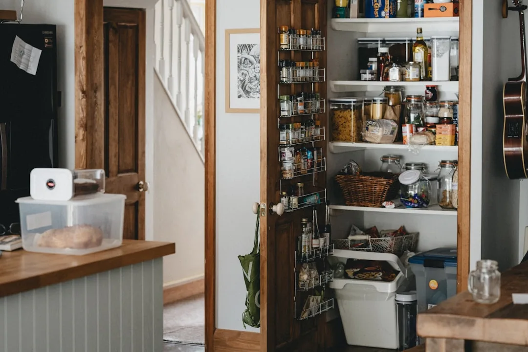 Open kitchen pantry with door-mounted spice racks