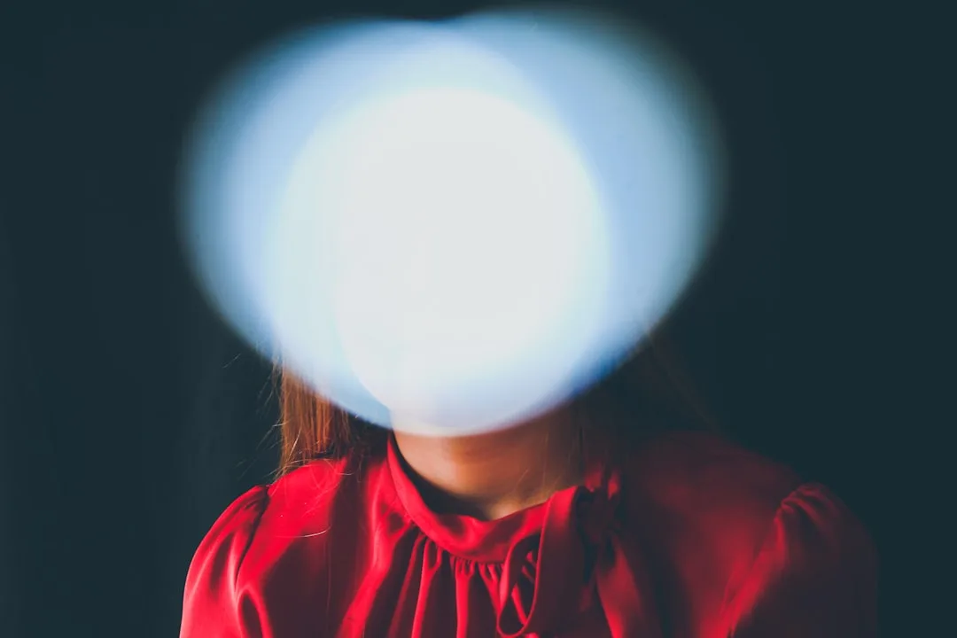 Portrait demonstrating harsh overexposed light obscuring a face, illustrating improper light placement relative to subje
