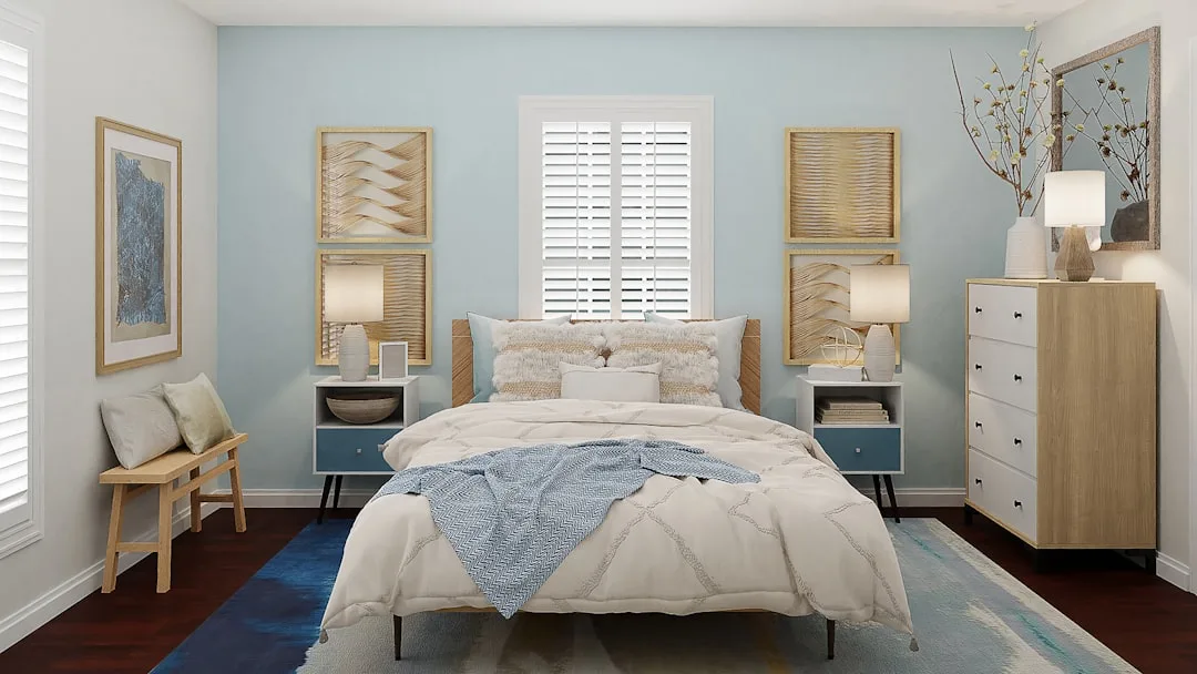 Calm bedroom with light blue walls, white bedding, and natural wood accents promoting restful sleep environment