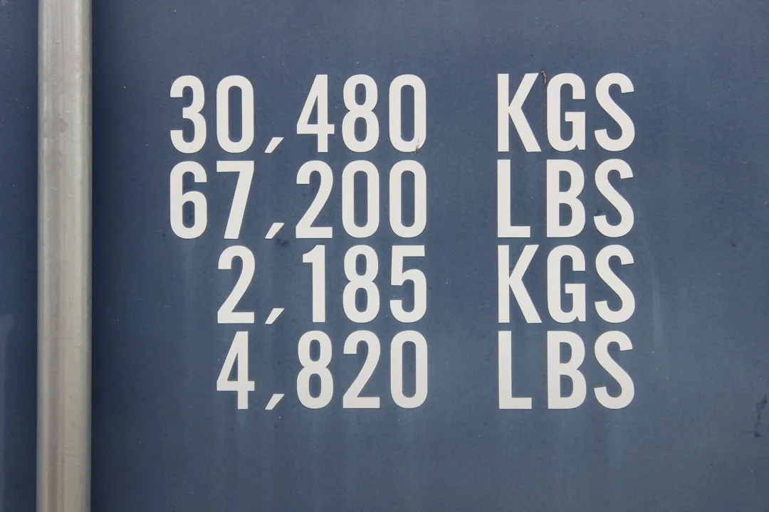 Shipping container weight capacity label showing 30480 KGS, 67200 LBS max gross and 2185 KGS tare weight