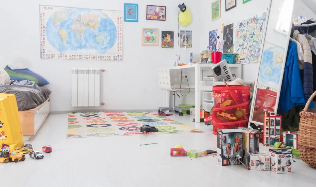 Messy child's bedroom with toys scattered on floor showing disorganized zones and activity areas