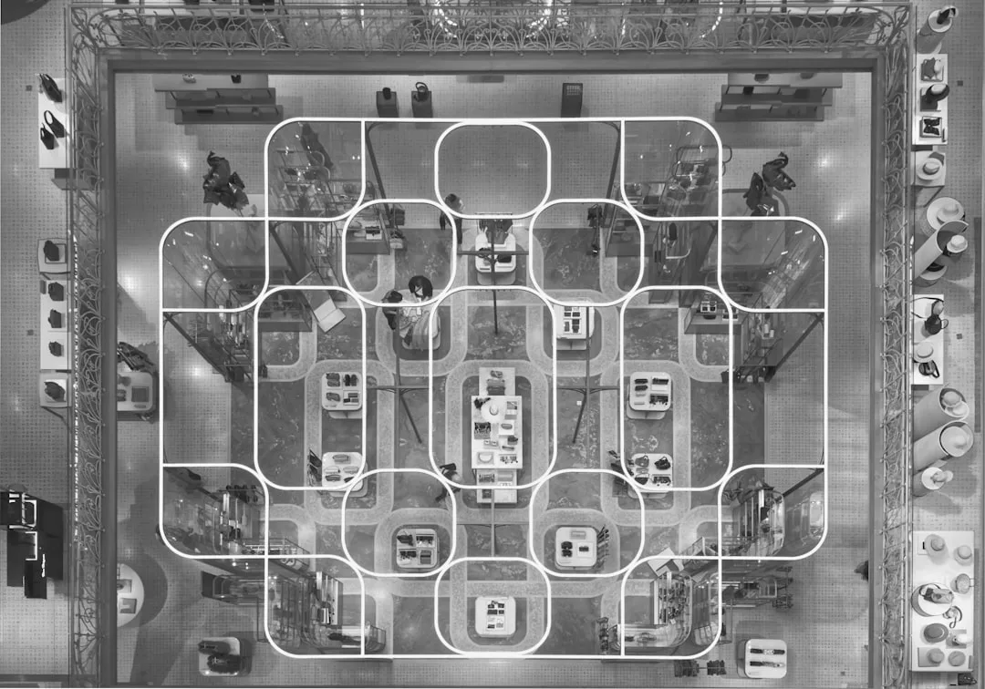 Aerial top-down view of retail store floor plan showing traffic flow patterns with curved white grid overlay