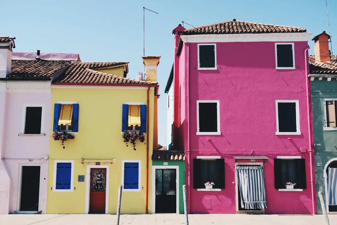 Colorful houses in Burano Italy with yellow pink and pastel exteriors showing saturated vs neutral color choices