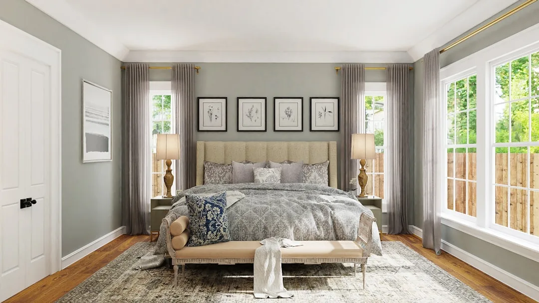 Bedroom with sage gray walls showing cool-green undertones, linen headboard, botanical prints, and natural wood floors
