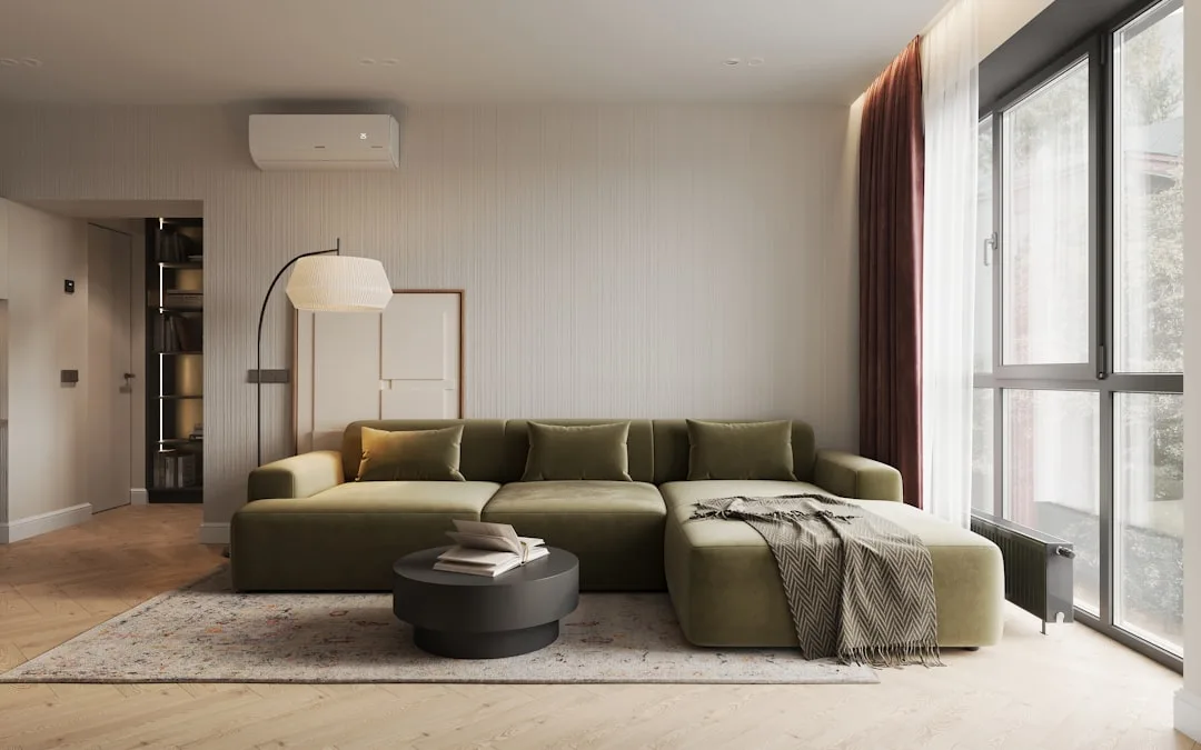 Large olive green L-shaped sectional sofa with area rug demonstrating the 2/3 rug-to-couch sizing rule in modern living 