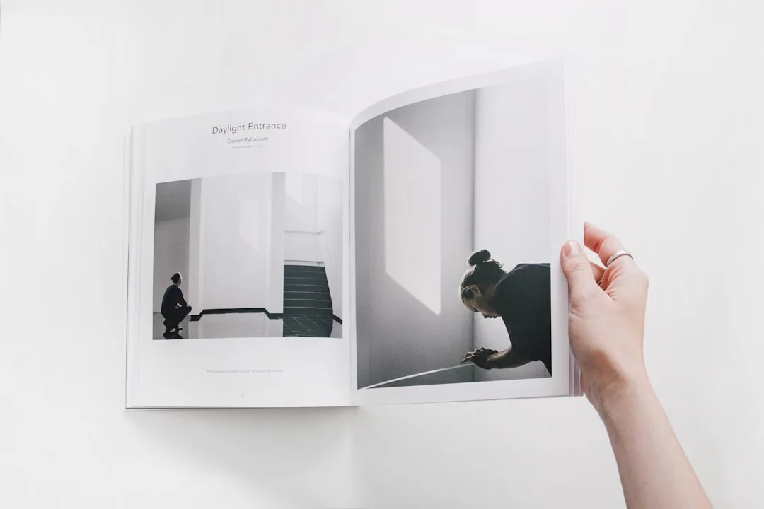 Open magazine showing minimalist architectural photography titled Daylight Entrance by Daniel Rybakken