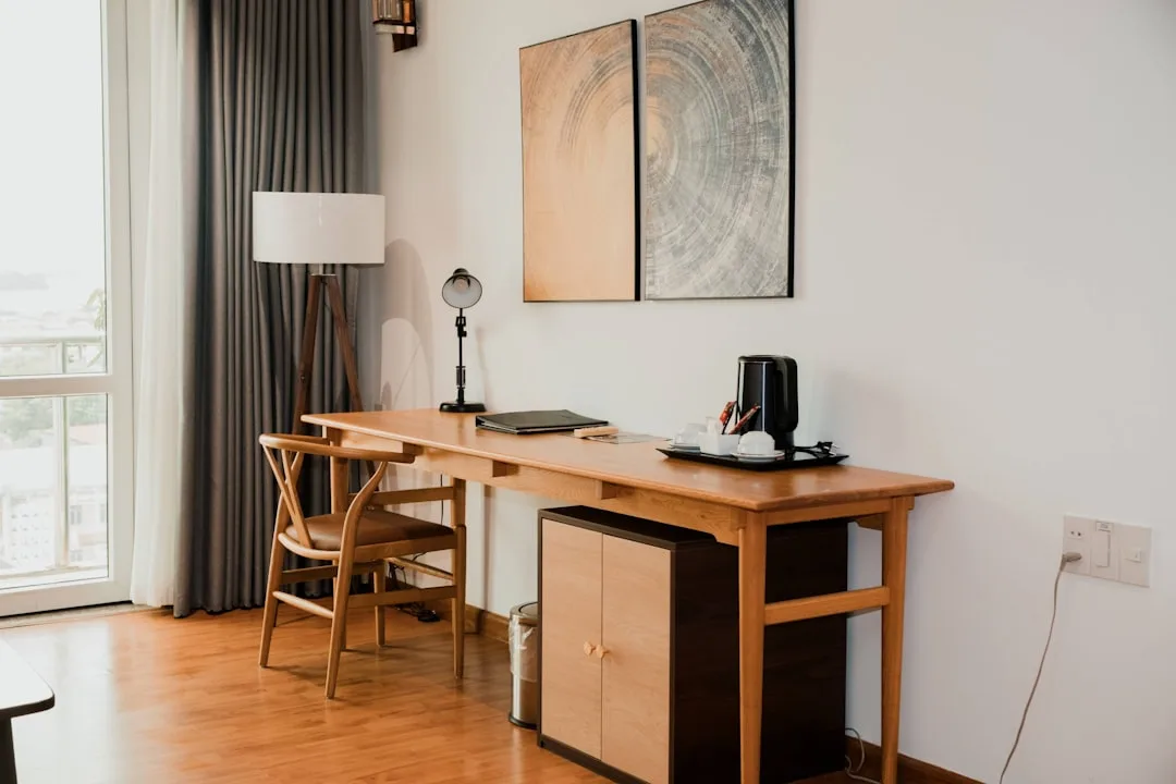Wooden desk with small cabinet unit in a hotel room, illustrating when to reconfigure or replace furniture storage