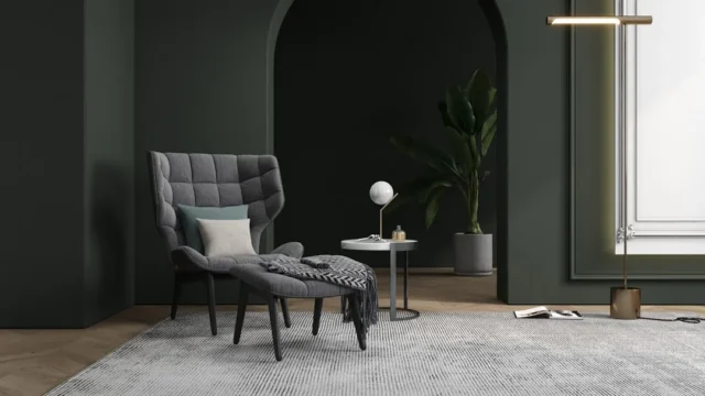 Gray tufted accent chair with ottoman placed in da
