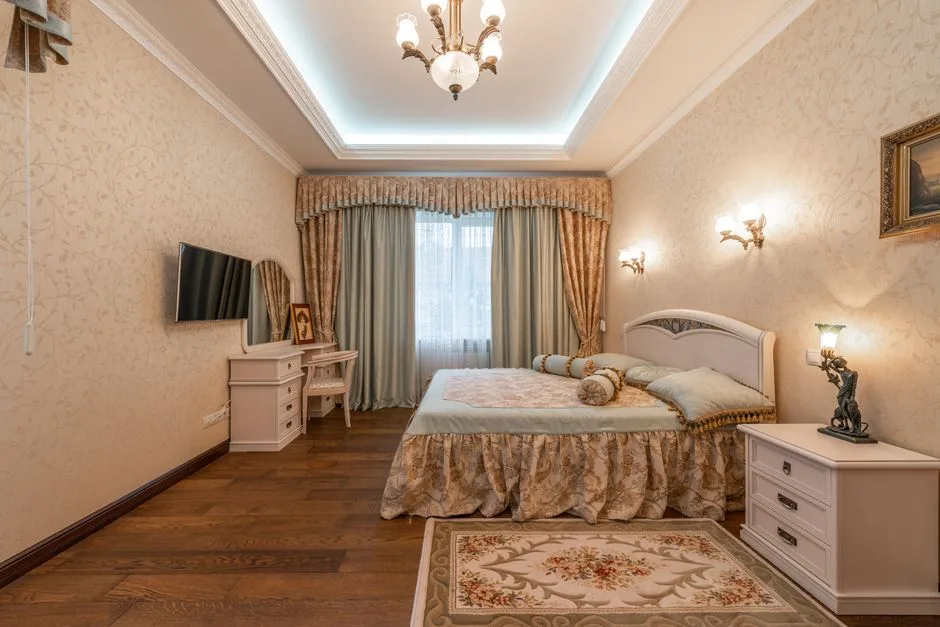 Wall sconces mounted on either side of bed in classic bedroom showing correct placement height above nightstands