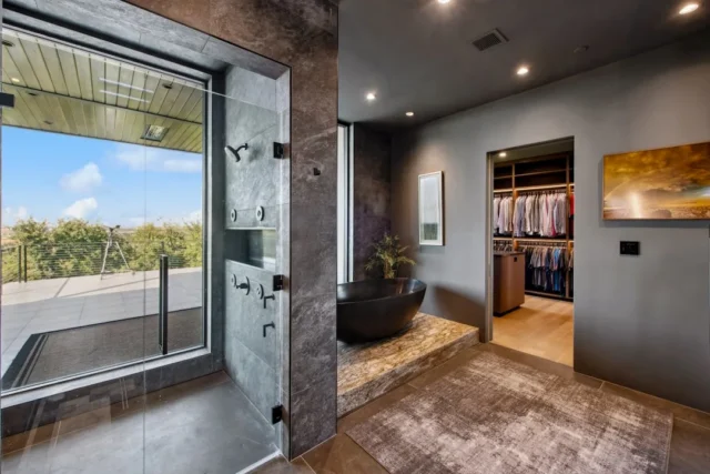 Luxury master bathroom with open walk-in closet co