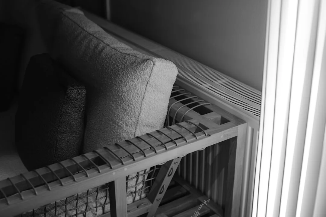 Built-in wooden shelf seating with cushions next t