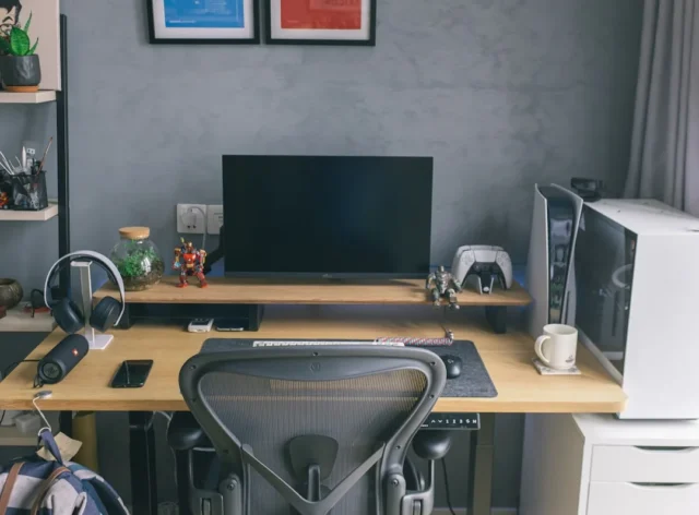 Compact home office desk setup with monitor, PS5 c