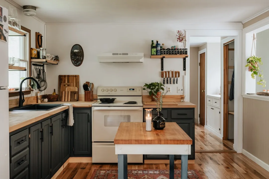 Small eat-in kitchen with dark cabinets, butcher b