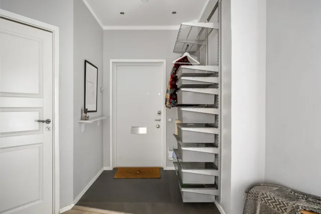 Open hall closet with pull-out wire baskets and ha