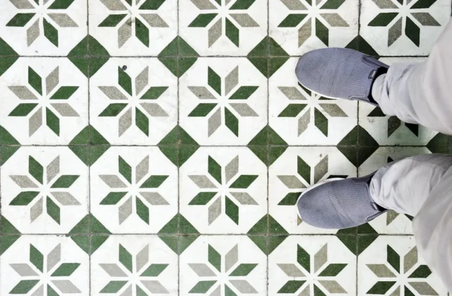 Person standing on decorative green and white geom