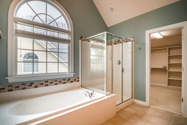 Primary bathroom with soaking tub, glass shower, a