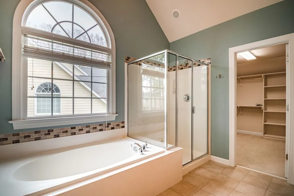 Primary bathroom with soaking tub, glass shower, a