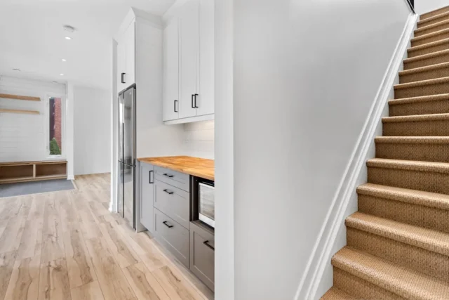 Modern built-in kitchenette with gray cabinets and