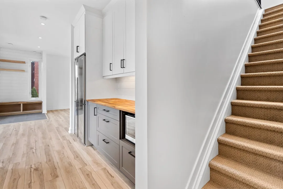 Modern built-in kitchenette with gray cabinets and