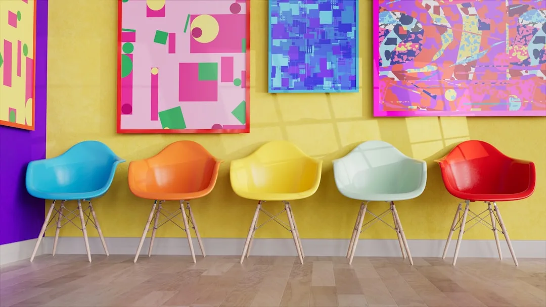Five colorful Eames-style chairs in blue, orange,