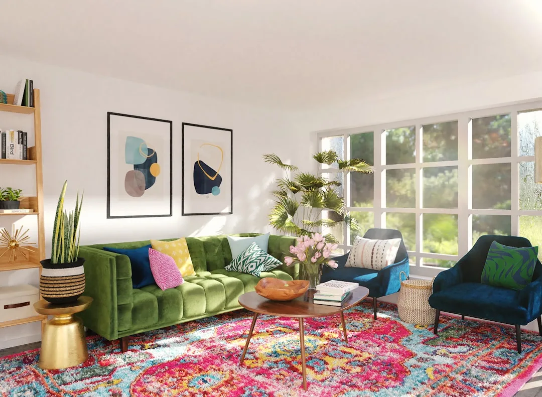 Colorful eclectic living room with green velvet tufted sofa, blue accent chairs, and vibrant patterned rug