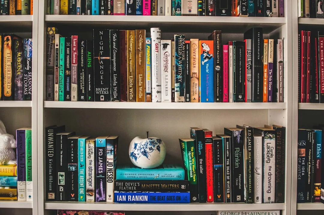 White bookshelf with books organized across multiple shelves using zone-based arrangement method